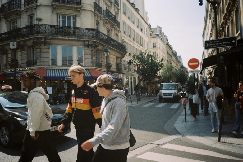 two people walk across the street in front of the traffic light