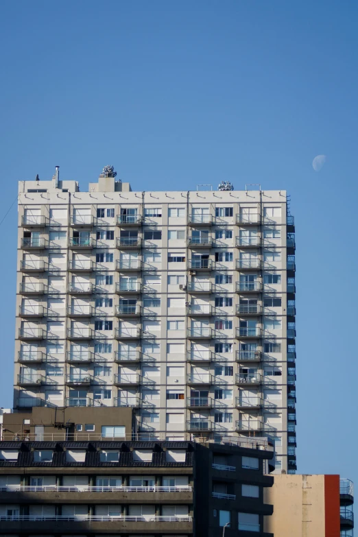 very tall buildings with balconies and windows on top