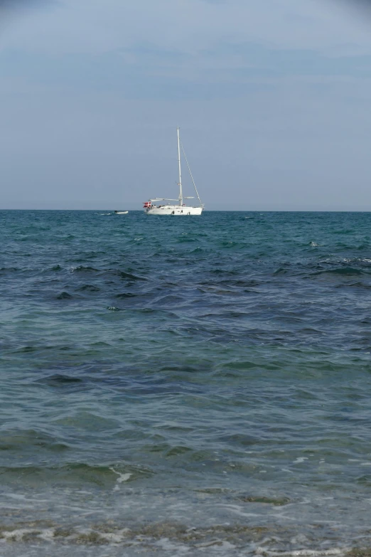 an open ocean with a large white boat in it