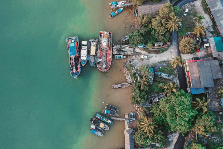 small boats on the water next to a village