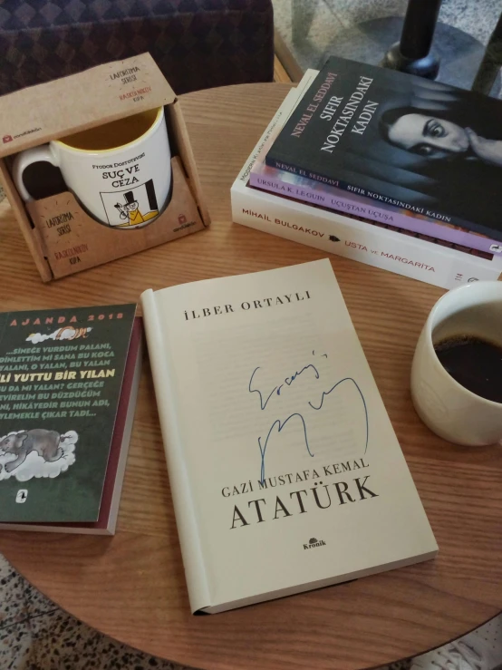 a table topped with books and a cup of coffee