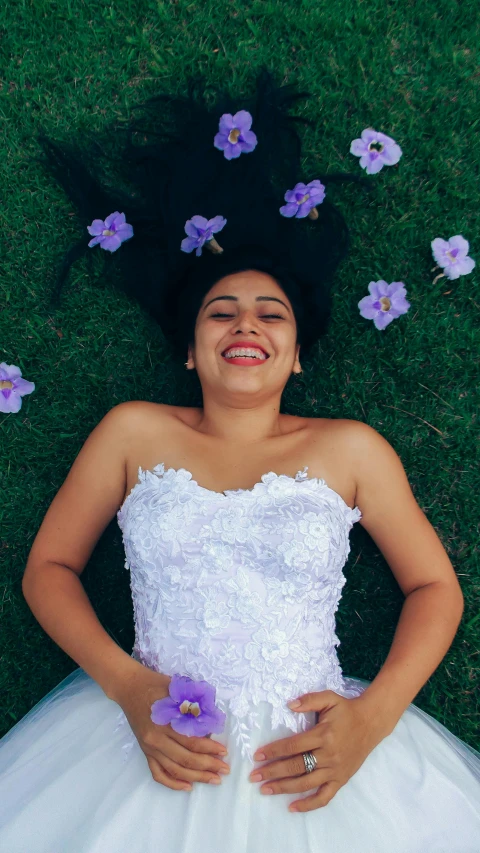 a woman posing for a pograph in the grass