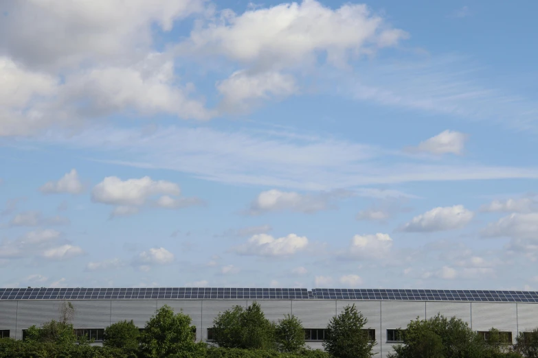 there is a white building and blue sky above