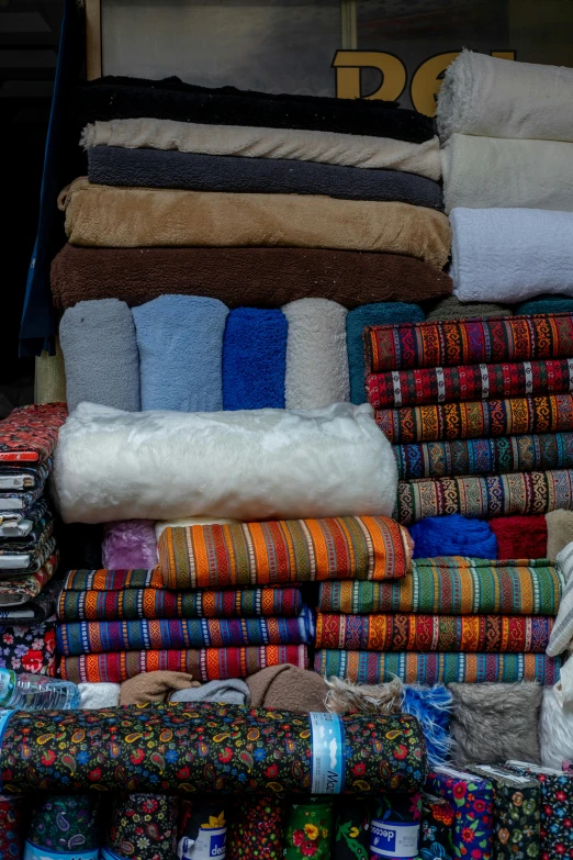 an outdoor place is filled with lots of blankets and throws