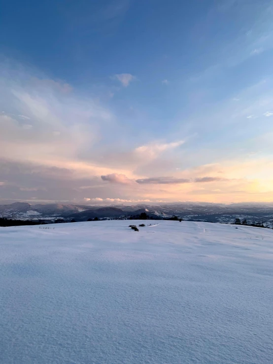 a snowy landscape of snow and a distant city in the distance