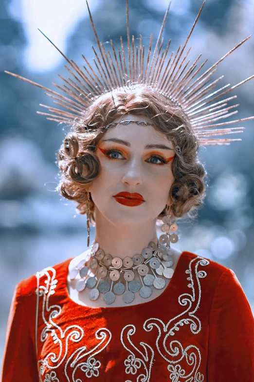 a woman wearing a dress with some silver beads on top