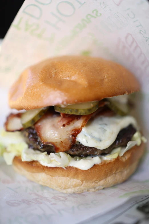 a hamburger sitting on top of a paper wrapper