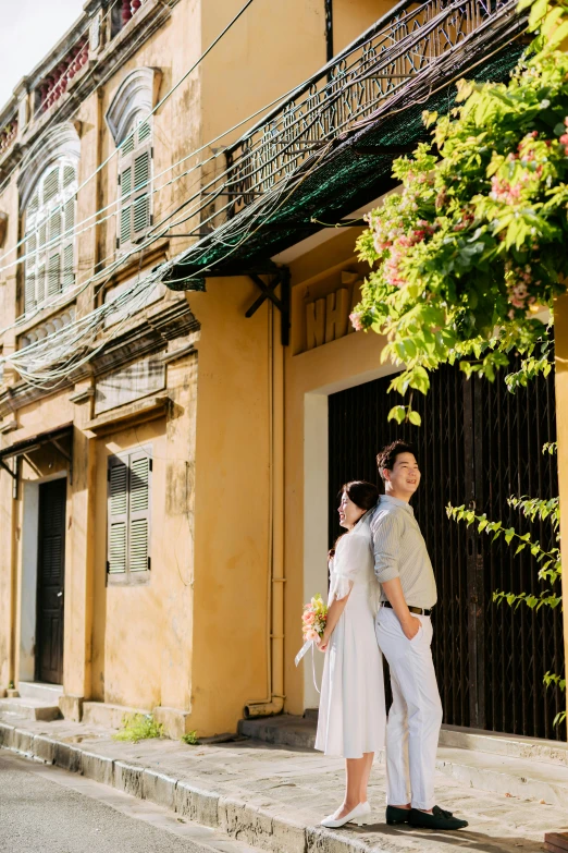 a couple standing on steps in front of a building