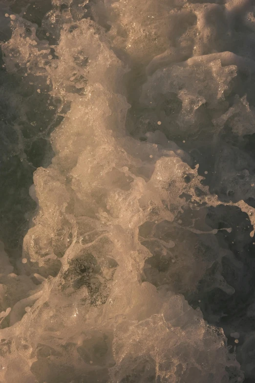 water bubbles near a body of water with gold colored streaks