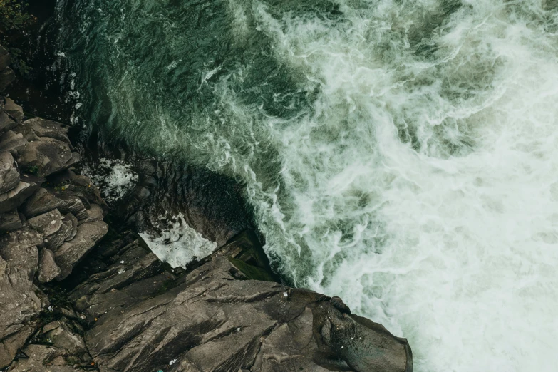 aerial view of water coming up from the cliffs