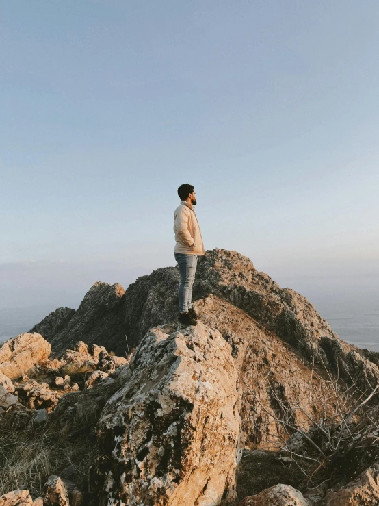 a man is standing on top of a mountain
