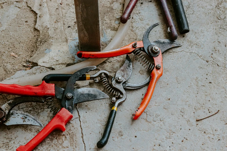 a set of tools laying next to each other on top of a concrete surface