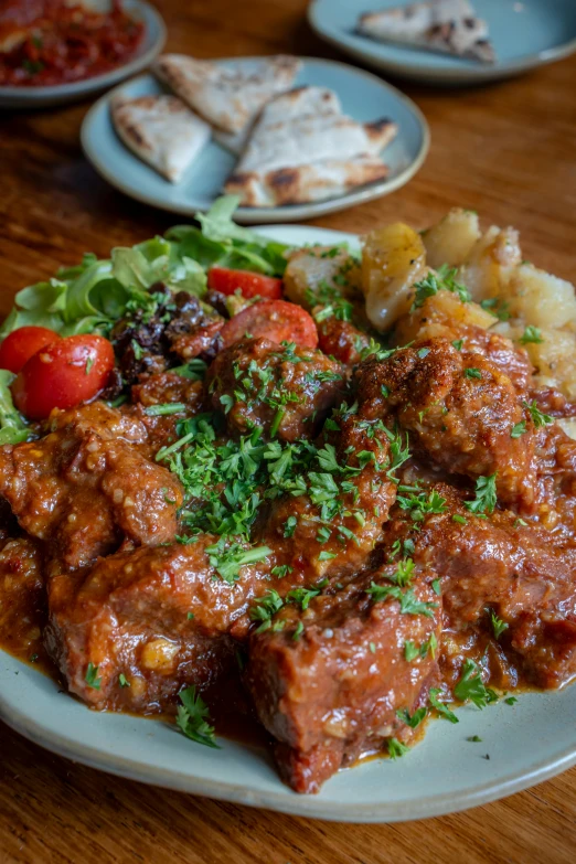 a meal consisting of meat with potatoes and salad on the side