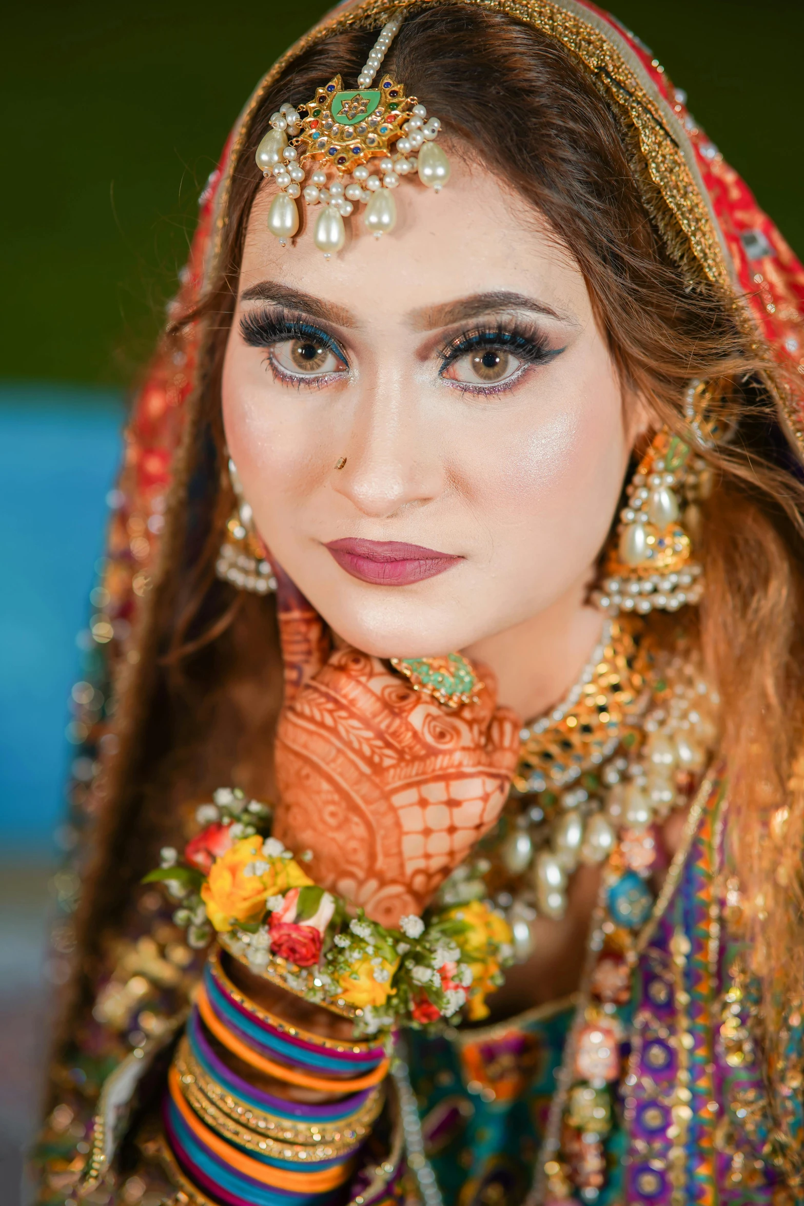 a bride is dressed in traditional bridal jewelry