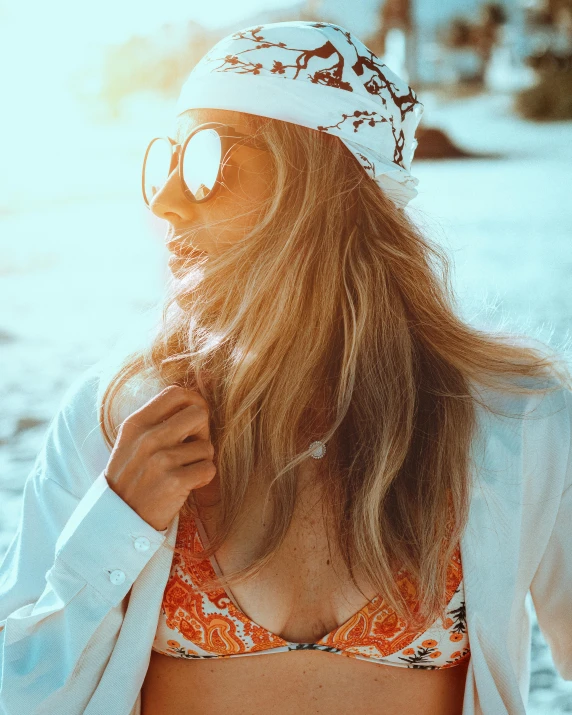 a woman in an orange , hat and sunglasses