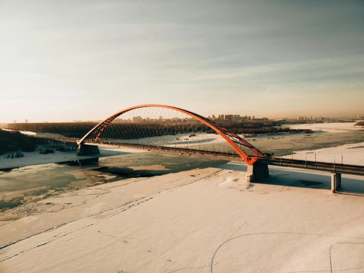 an overhead view of snow covered ground and bridge