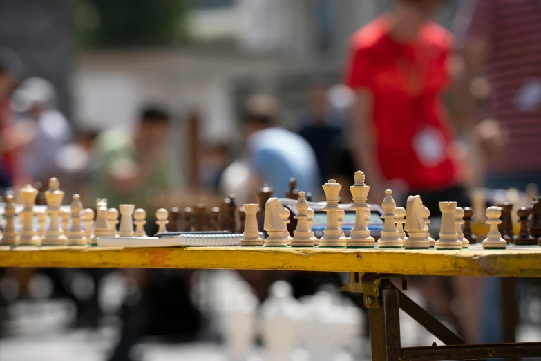 several pieces of chess sitting on the ground, all lined up