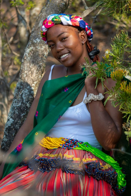 a woman smiles brightly in her colorful dress