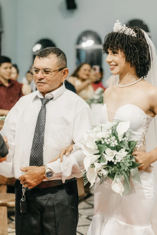 bride and father smiling in a church