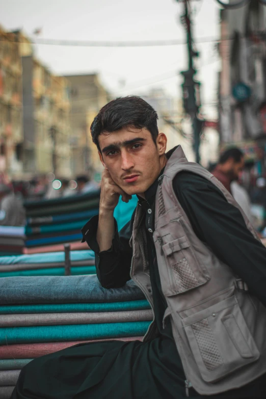 a man on the phone while sitting on some benches