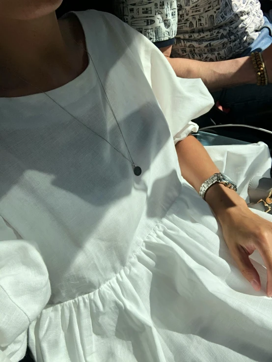 an image of woman sitting on bench in front of others