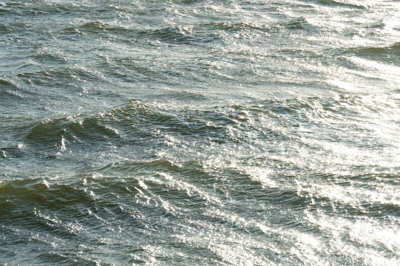 the surfers is on his surfboard in the middle of a big body of water