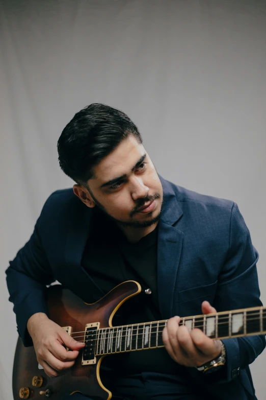 a man playing a guitar on the stage