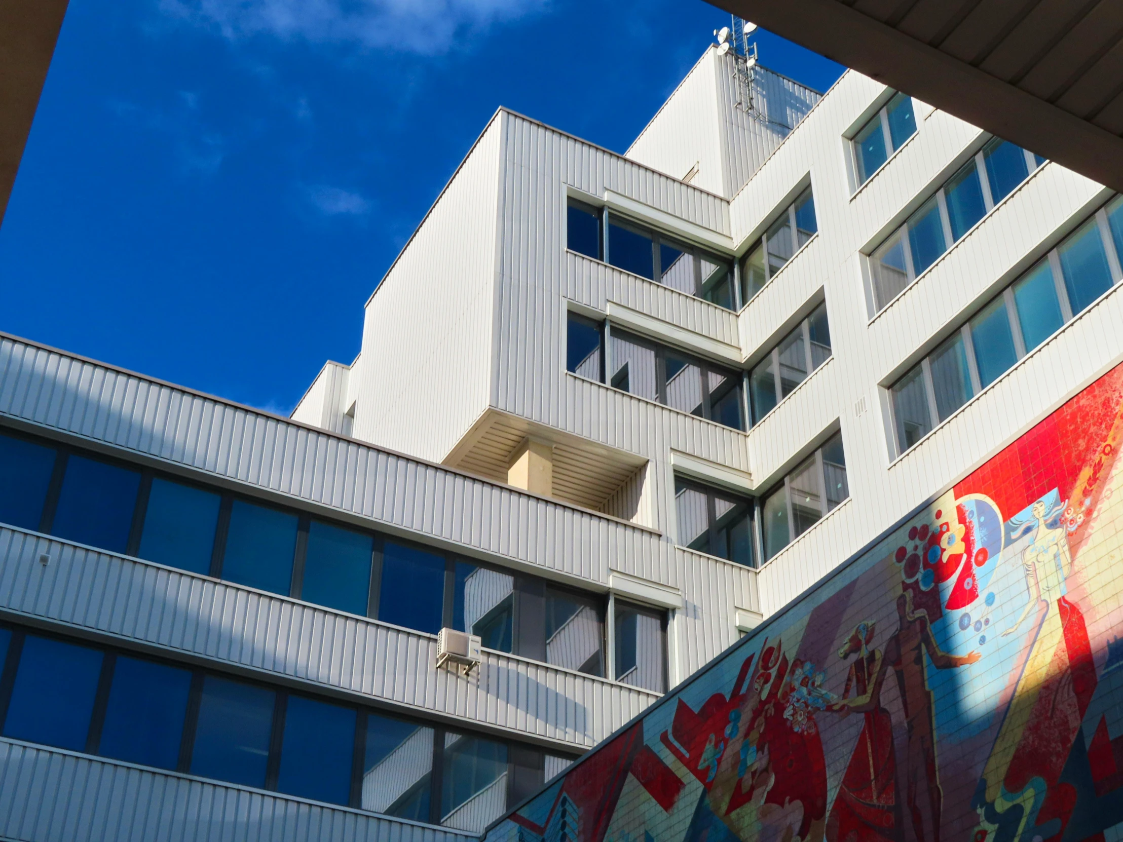 a high rise building with colorful signs and windows