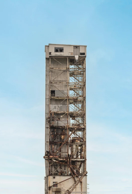 a tall structure with scaffolding up against a blue sky