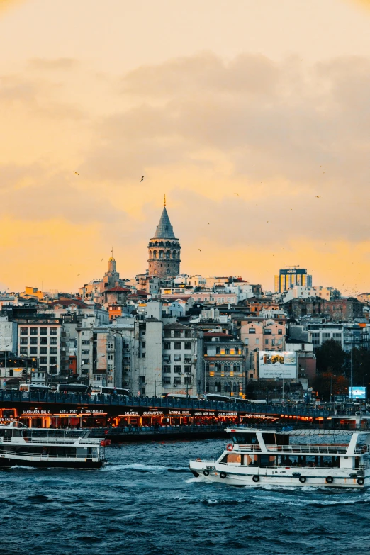 several boats traveling in a river with buildings in the background