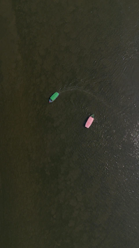 three small floats floating on the water together