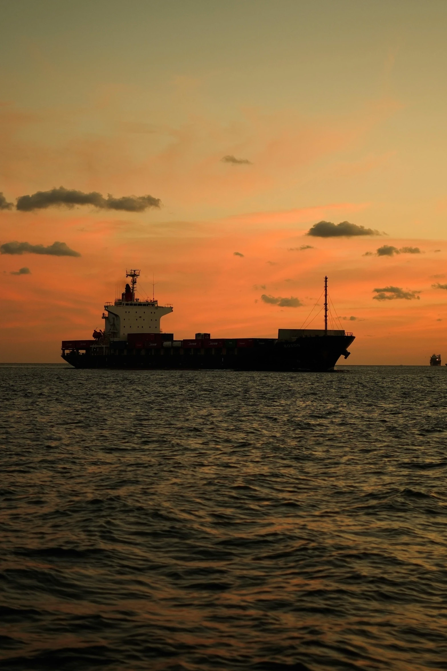 a large boat out on the water at sunset