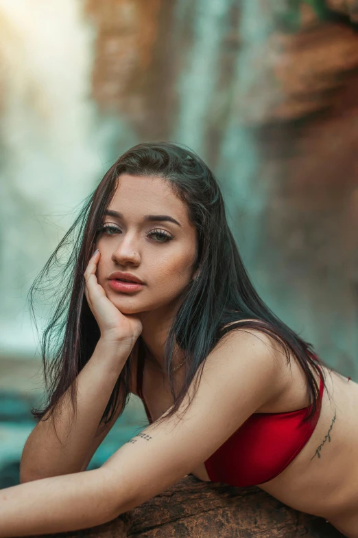 a woman in a bikini laying on the ground