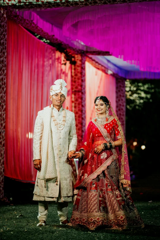 the bride and groom posing for the pographer on their wedding day