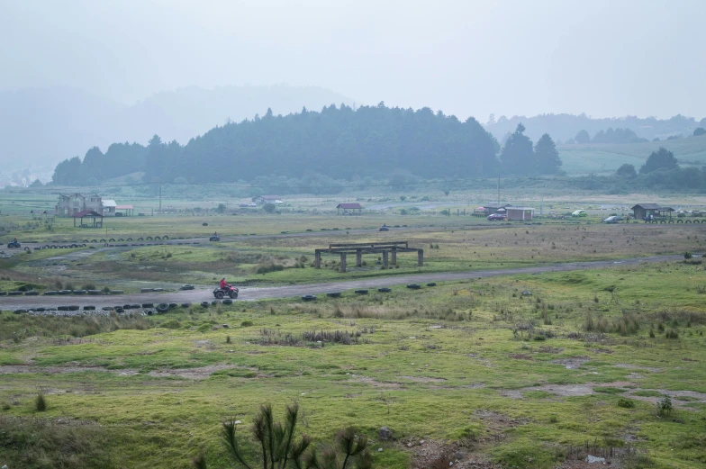 the dirt road is very dusty and the cow pasture is far away