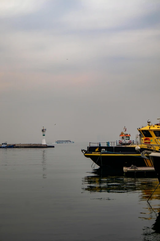 a large ship passing in front of some other boats