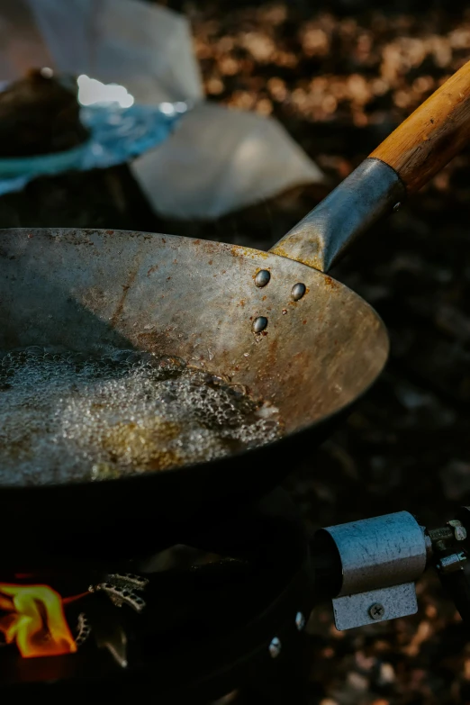 frying pan with  oil in outdoor setting