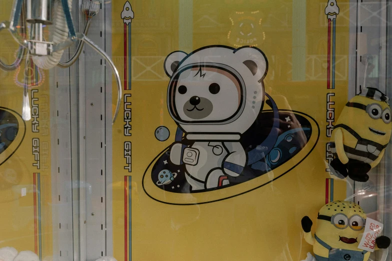 a yellow package containing teddy bear with a space suit on