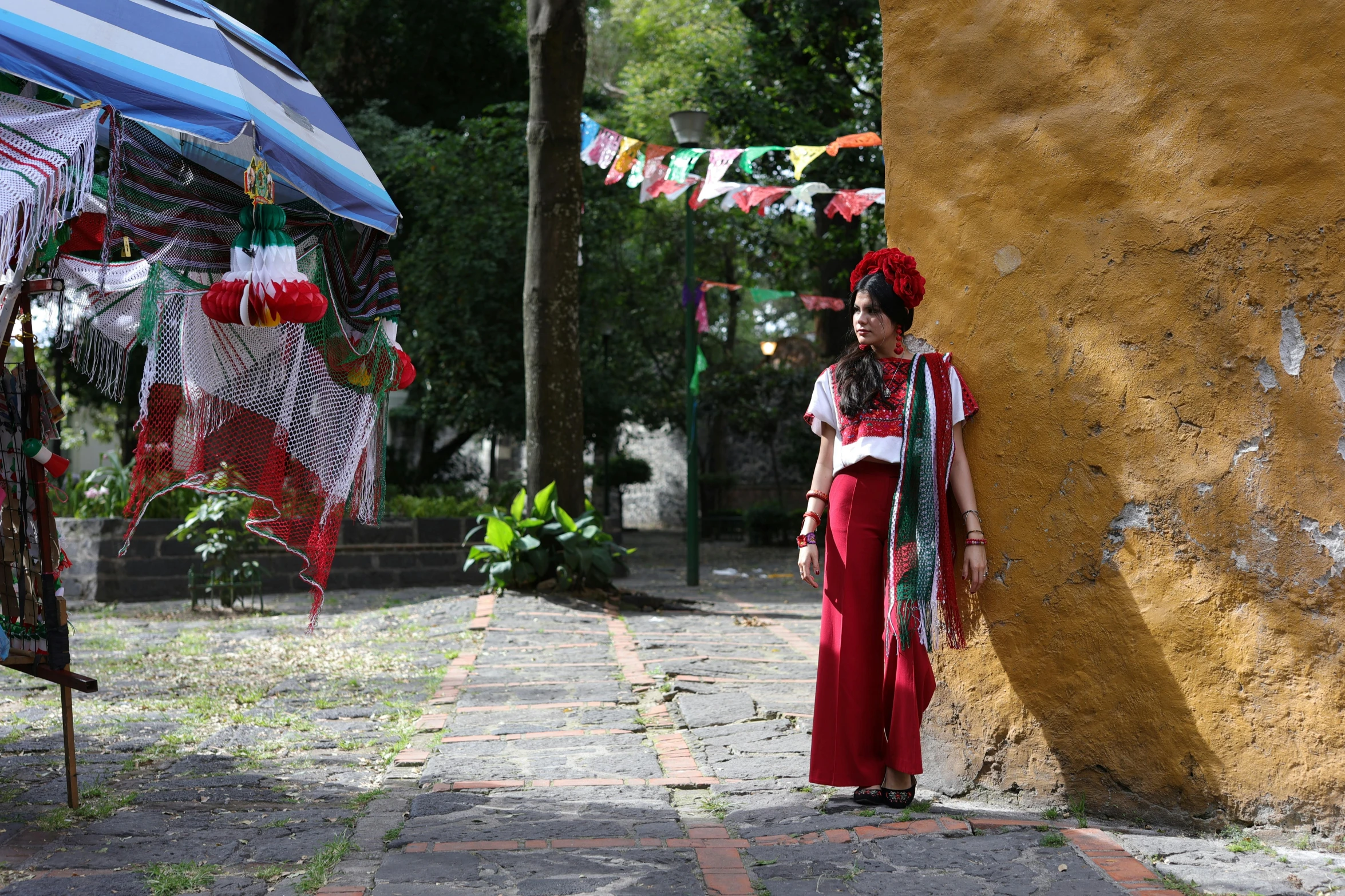 there is a woman standing by a tree