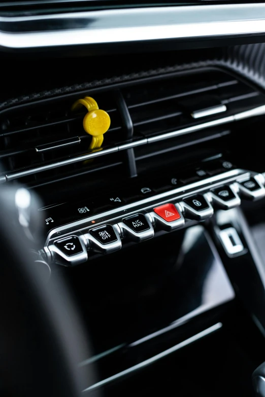 a car air vent with yellow s and black trim