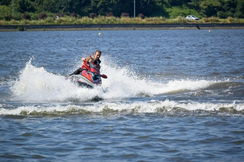 two people riding jet skis on a lake