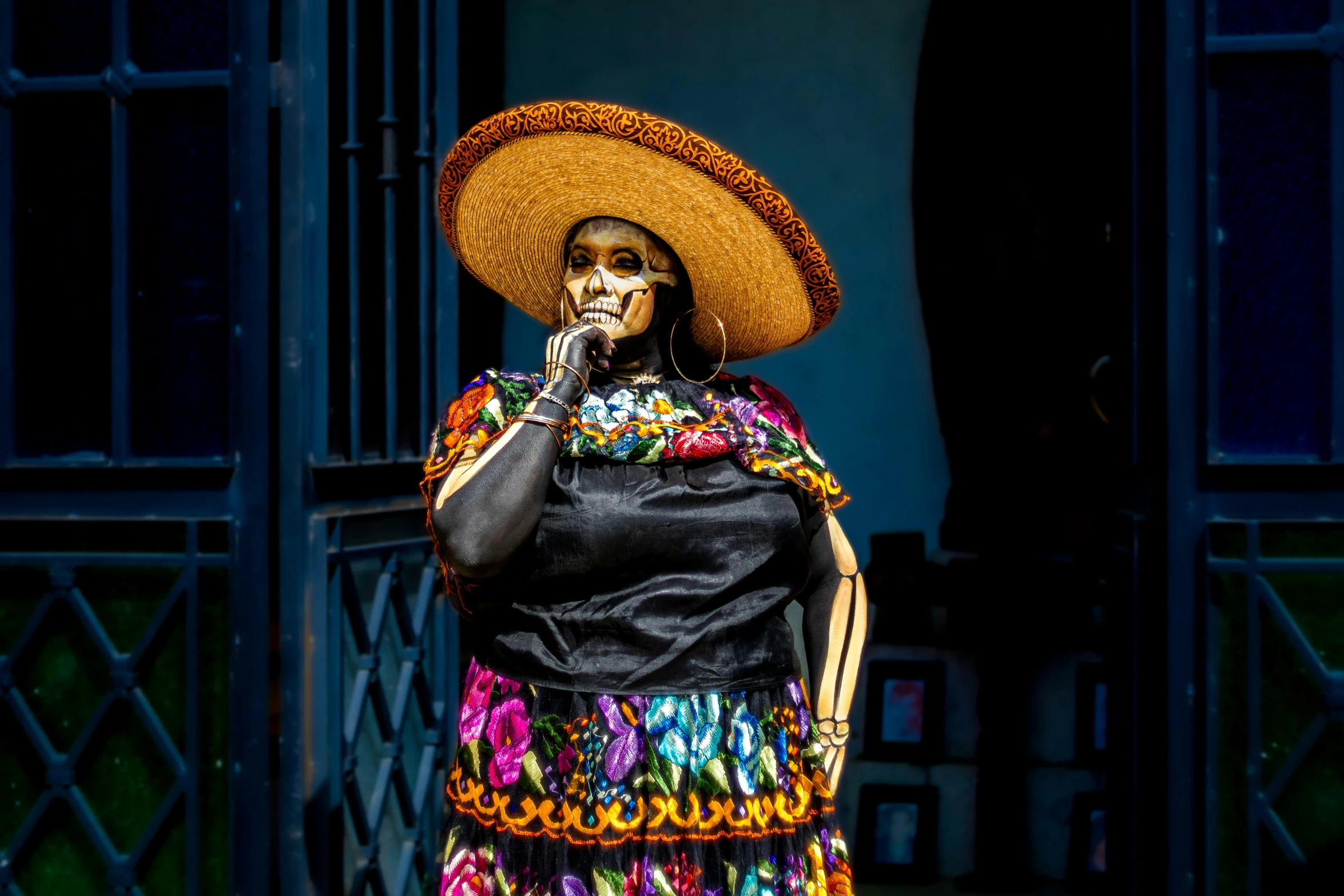 a woman wearing a sombrero and holding a cane