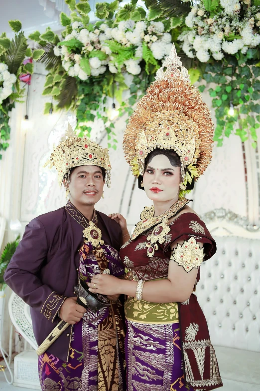 two people dressed in colorful costumes are posing