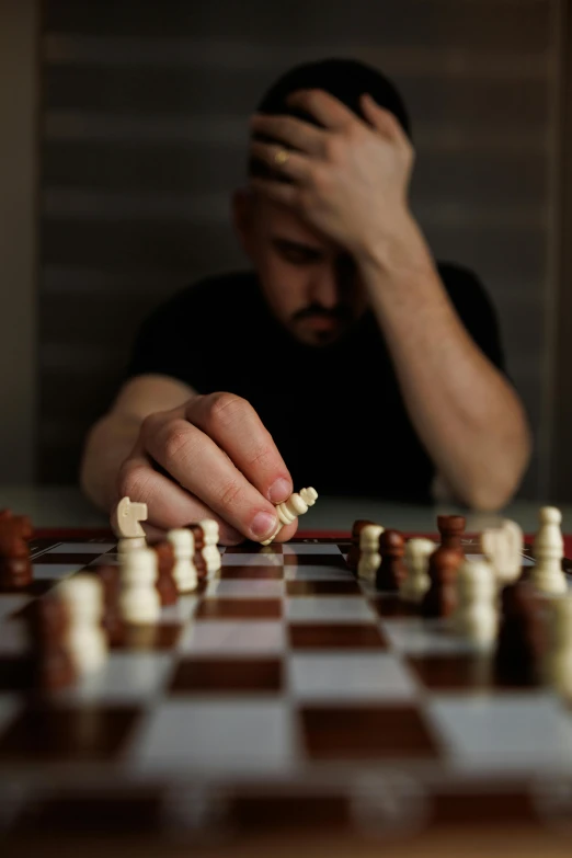 a man sitting in front of a chess board