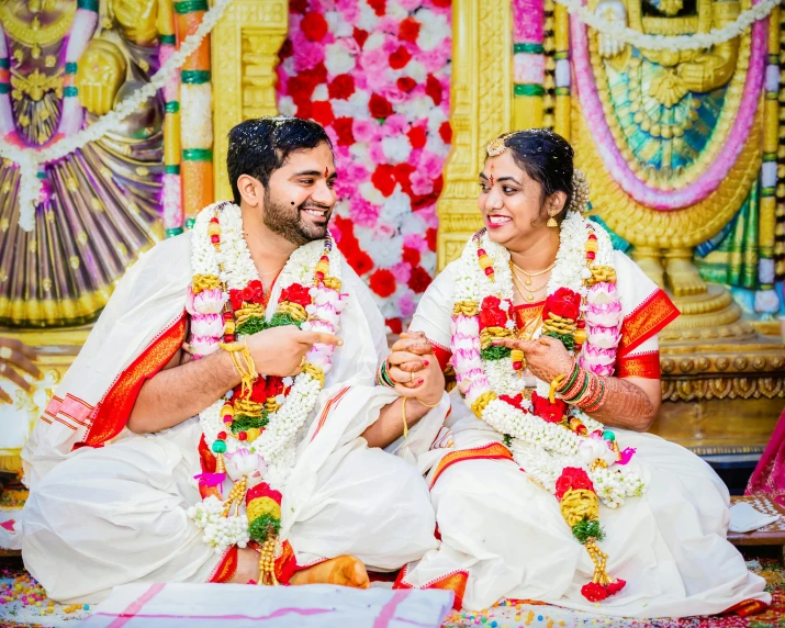 the newly married couple are in their traditional dress