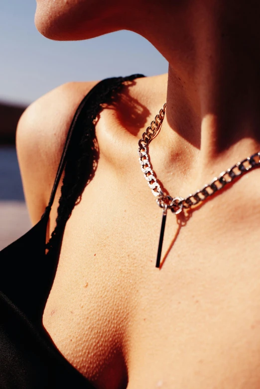 woman in a bikini shirt, neck piece with chain