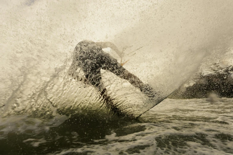 a person riding a surfboard in the water with waves