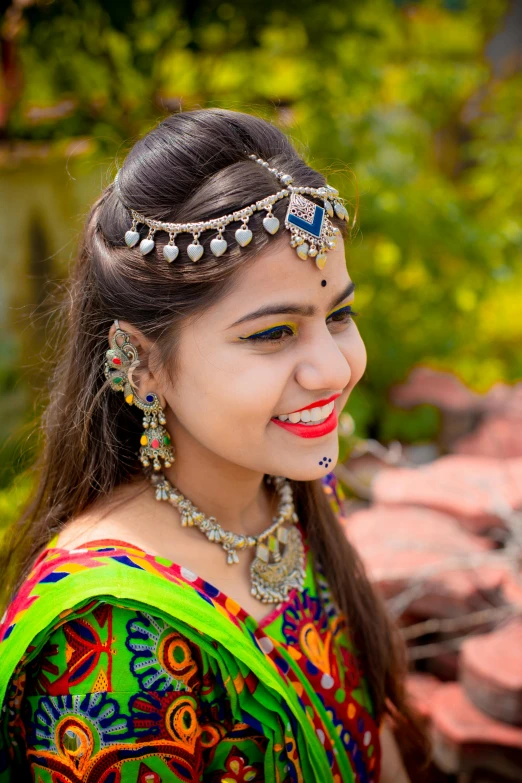 a woman wearing an ethnic style hairpiece smiling
