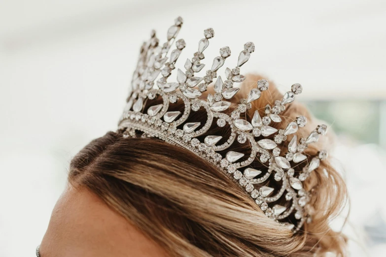 a woman with long hair wearing a silver crown