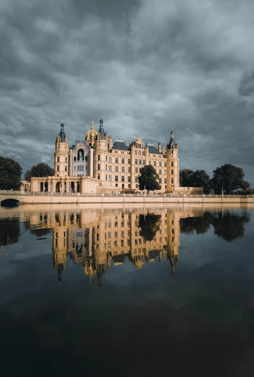 a very large castle sitting in the middle of the water